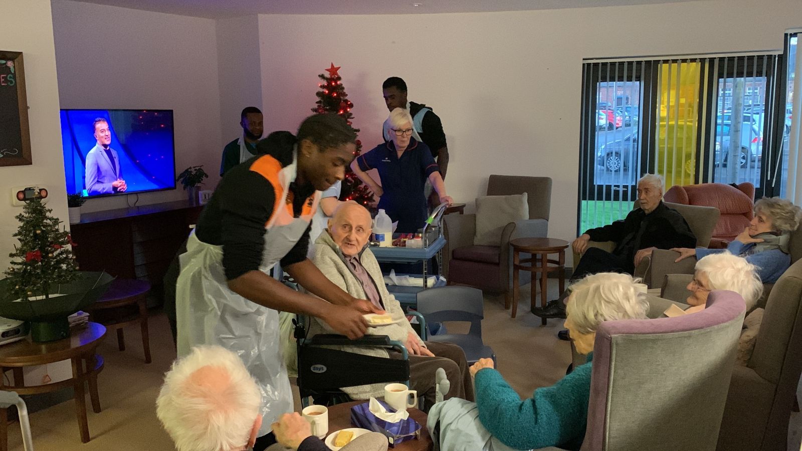 CJ Clarke and Jed Abbey help the Haven Court team serve drinks and treats to residents..jpg