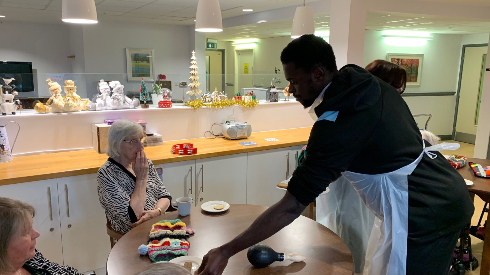 SSFC player Jed Abbey serves up to Haven Court residents..jpg